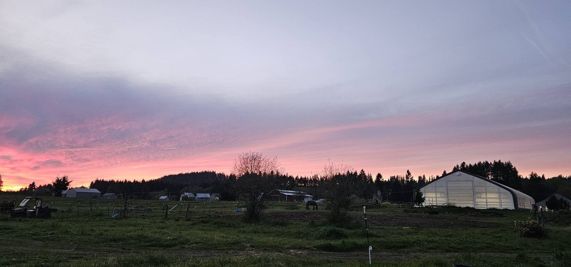 Sunset over the pastures and covered arena